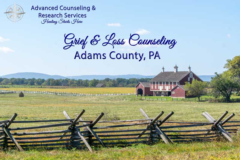 Serene Pennsylvania countryside path at golden hour symbolizing the journey through grief toward healing for Adams County, PA residents