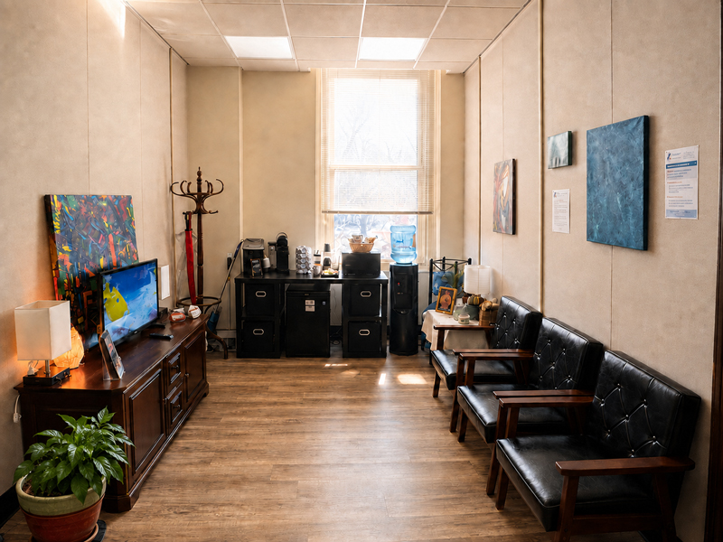 Waiting area at Advanced Counseling and Research Services in Lancaster, PA, with comfortable seating, natural light, complimentary coffee and water, and original artwork